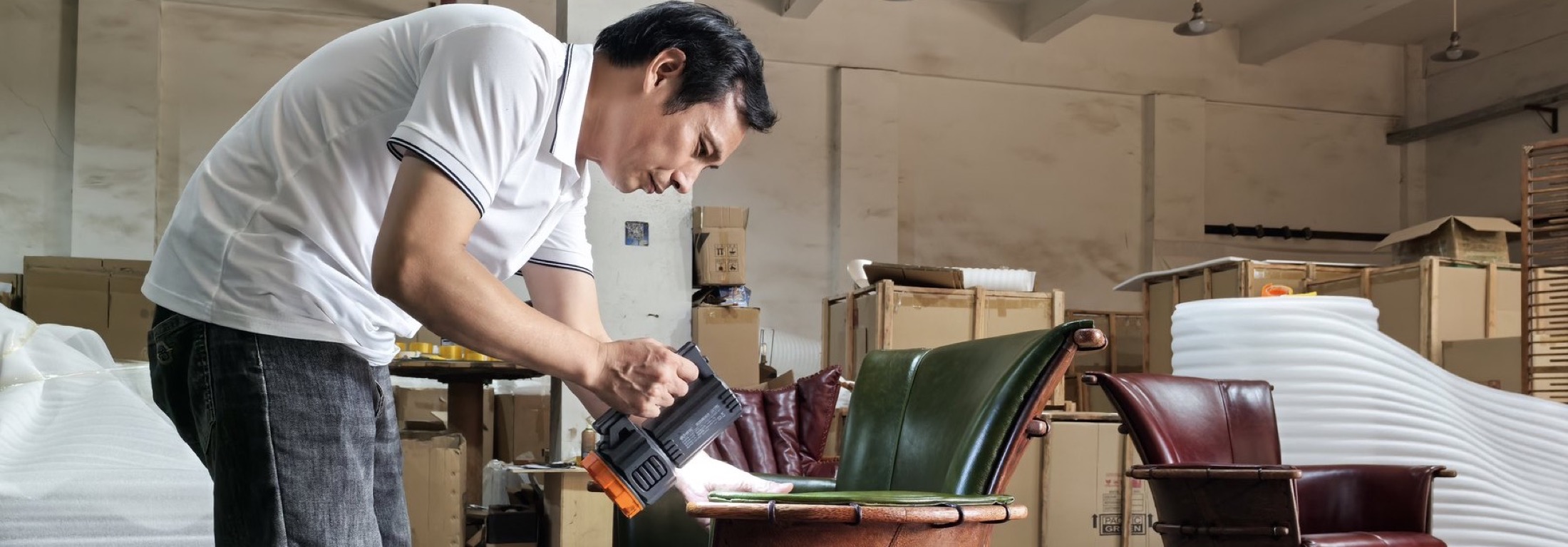 Pacific Green quality inspector checking leather furniture in the workshop