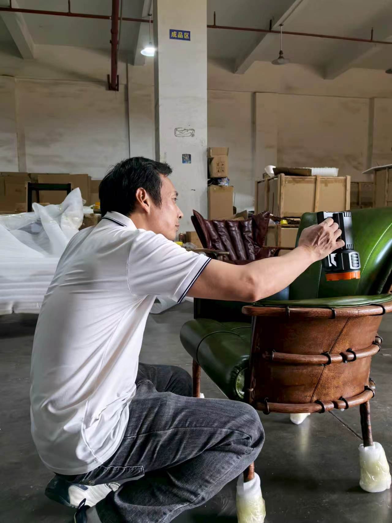 Pacific Green quality inspector checking a leather chair from the side